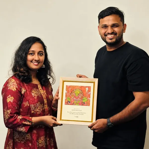 Student Surya receiving her mural certificate